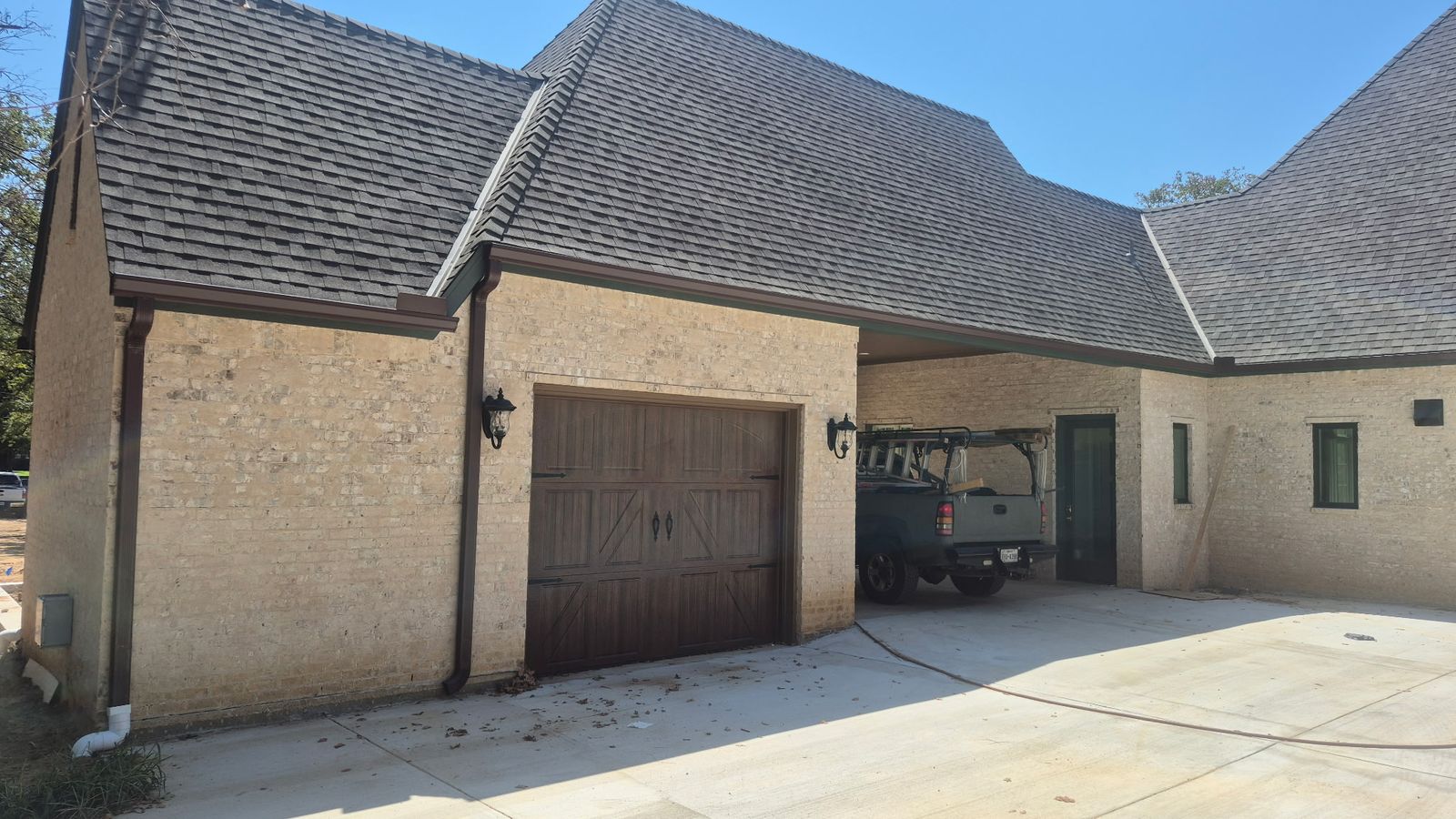 Single-car wood-look garage door installed on a DFW home